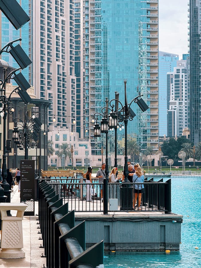 Tourists Enjoying the Waterfront Promenade Amidst Skyscrapers in Downtown Dubai
